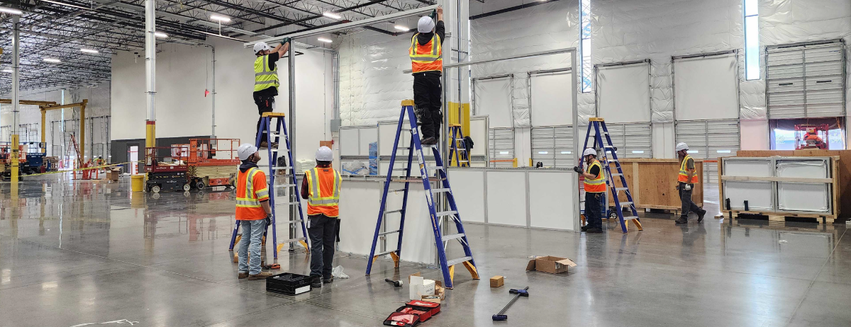 blog-cover-designing-shielded-enclosures Engineers installing a large shielded room made by TotalShield